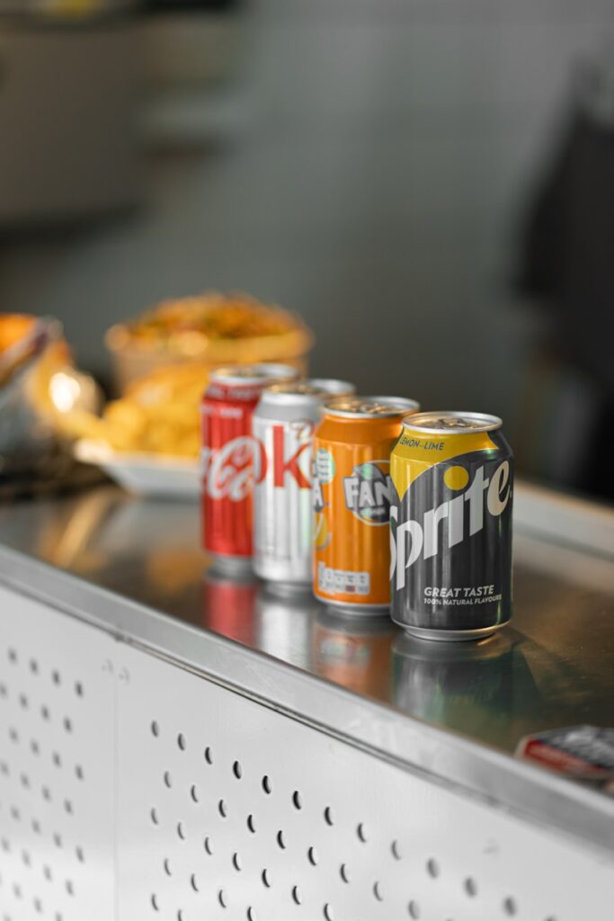 two coca cola cans on stainless steel table