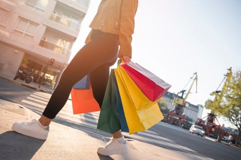 young-lady-with-shopping-bags-street_23-2147960710