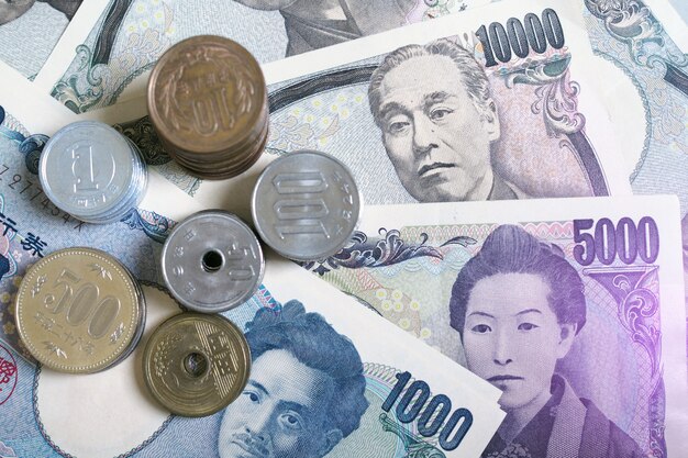 japanese-yen-notes-japanese-yen-coins-money-concept-background-picture-has-purple-light_112699-150